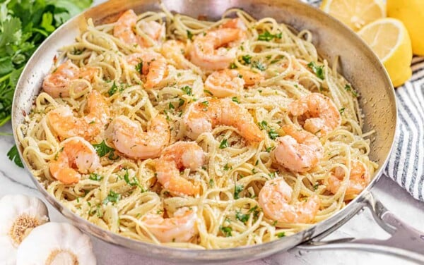 A stainless steel skillet filled with shrimp scampi.