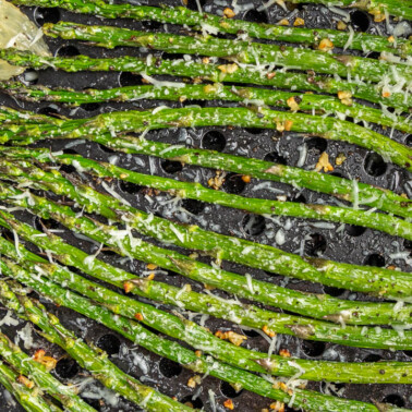 Close up overhead view of asparagus in an air fryer.