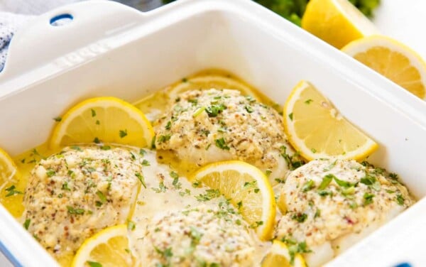Close up of lemon baked codfish in a baking pan.