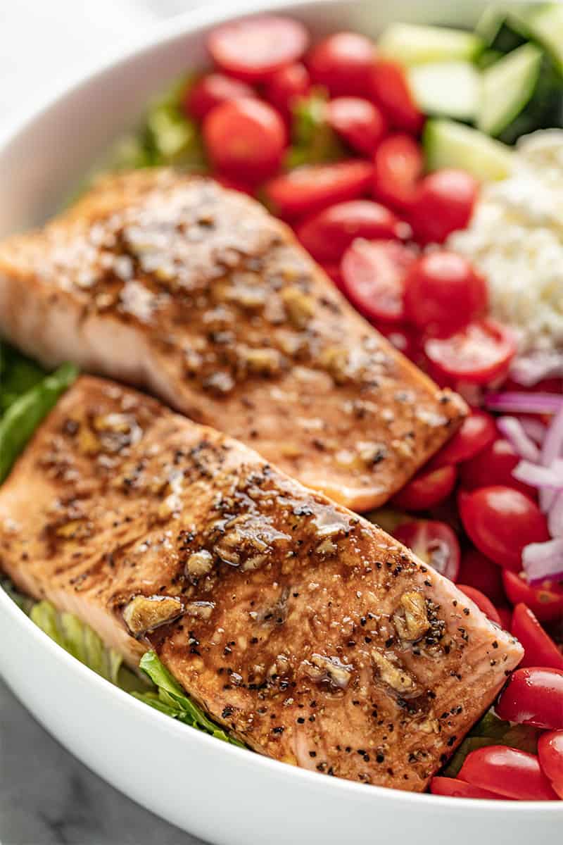 Close up of Balsamic Salmon Salad in a white bowl.
