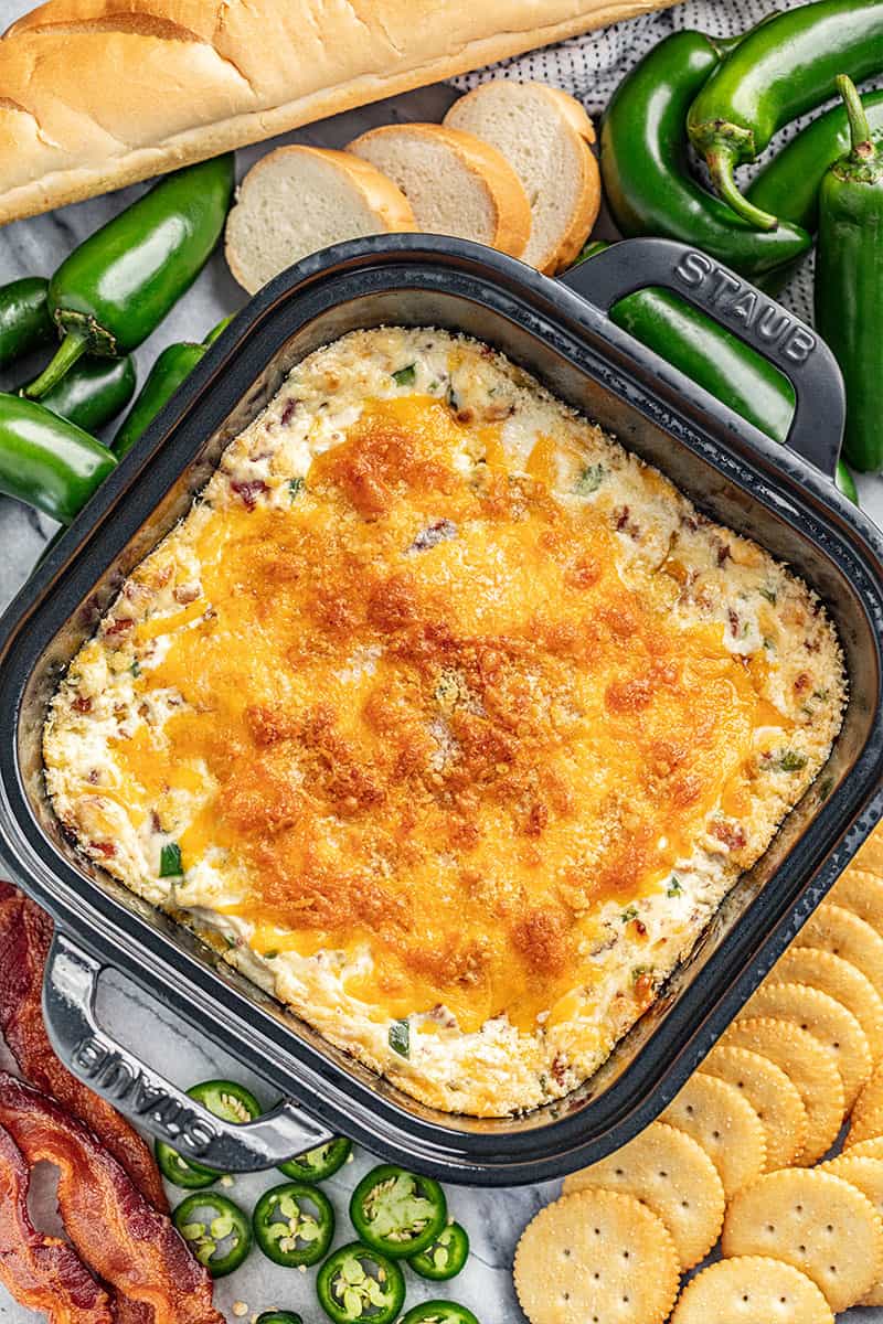 Overhead view of cheesy jalapeno popper dip in a baking dish.