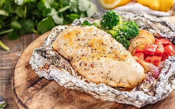 Chicken and veggies in a foil packet opened up.