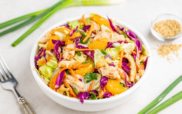 Chinese chicken salad in a white serving bowl.