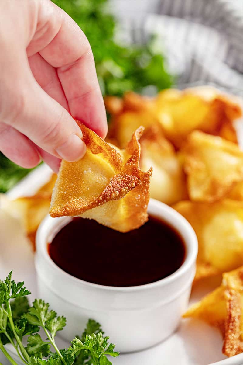 A cream cheese wonton and sweet and sour sauce.