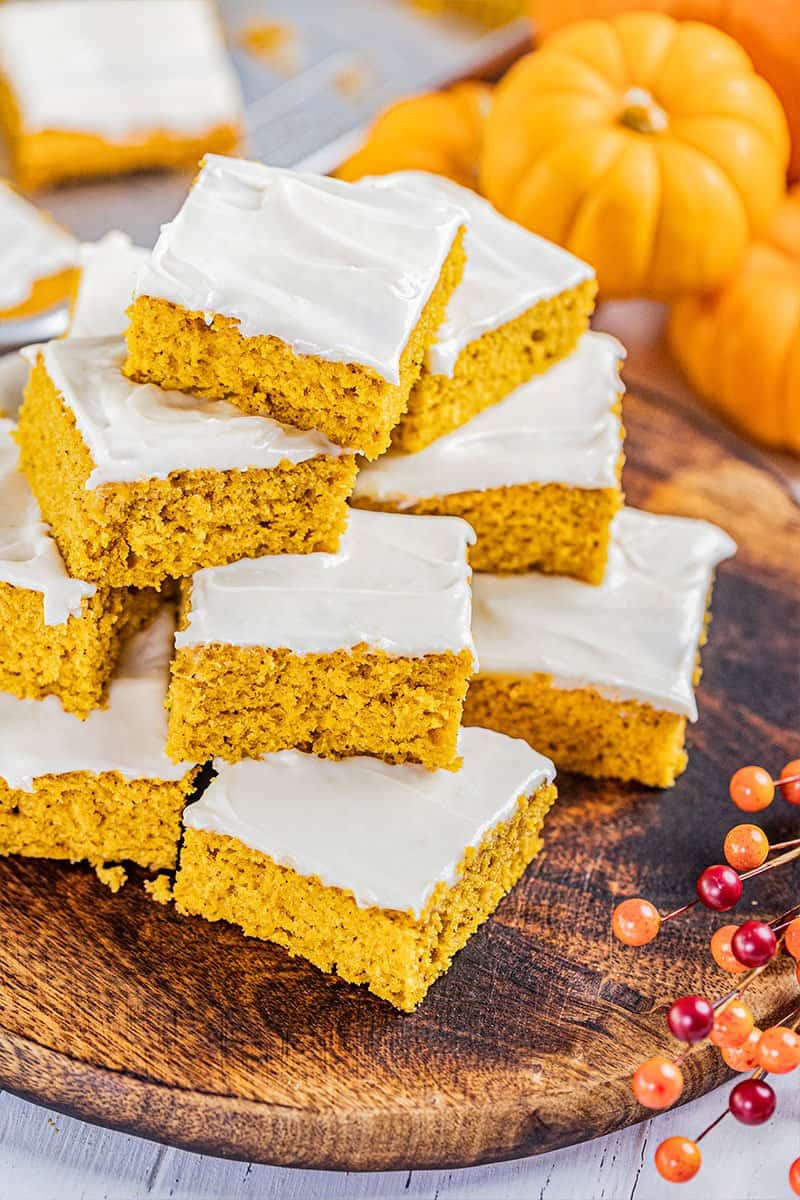 A stack of pumpkin bars on a serving tray.