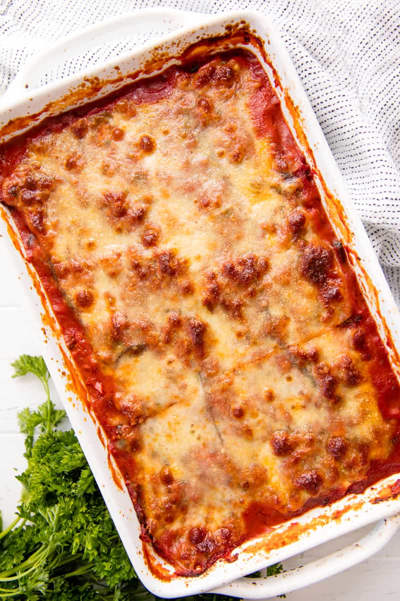 Eggplant Lasagna in a casserole dish, topped with bubbly cheese