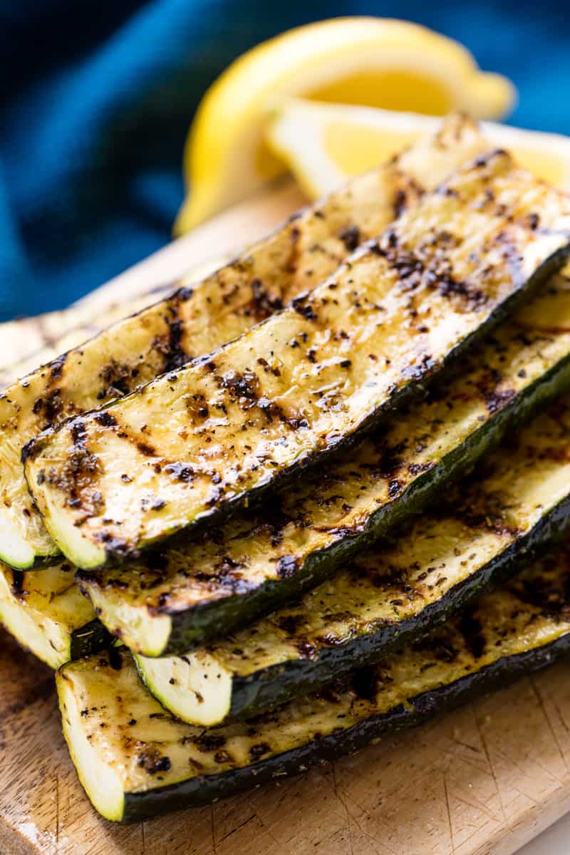 A stack of Grilled Zucchini on a cutting board.