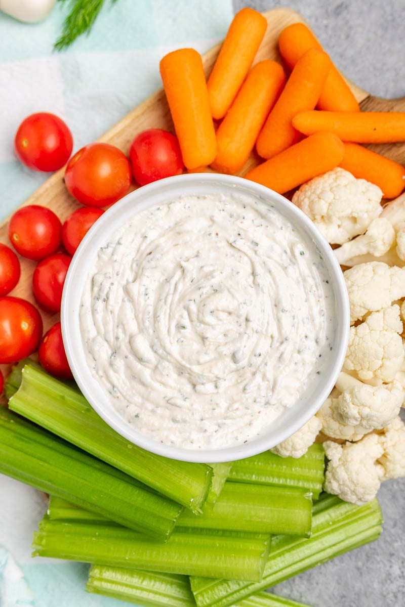 Overhead view of a white bowl filled with homemade ranch dip.