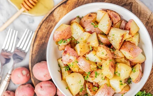 Overhead view of a bowl filled with honey roasted potatoes.
