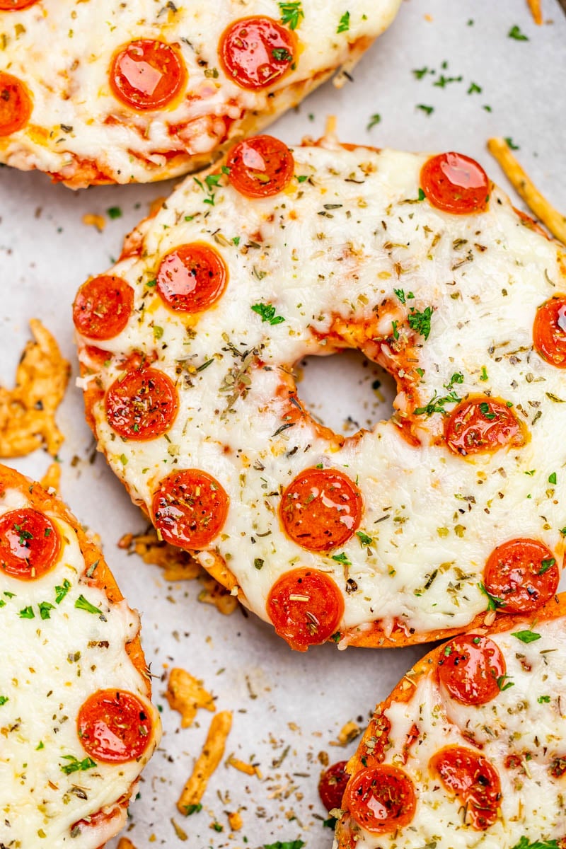 Overhead close up view of pepperoni pizza bagels.