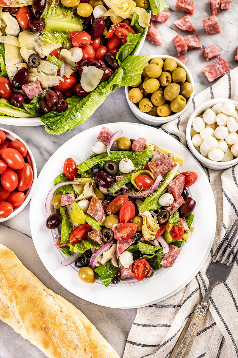 Overhead view of antipasto salad on a salad plate.