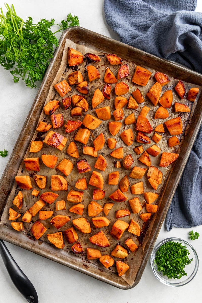 Overhead view of sweet potato cubes on a baking sheet.