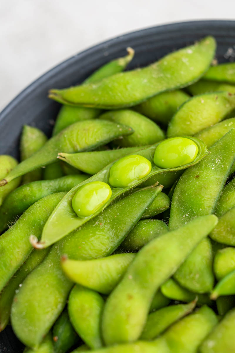 Extremely close up view of edamame in an open pod.