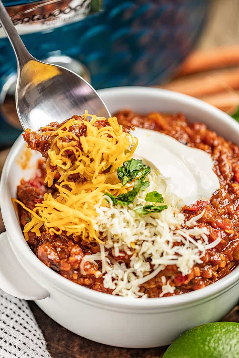 A spoon dipping into a bowl of Texas Chili.