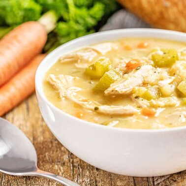 Slow cooker turkey soup in a white bowl