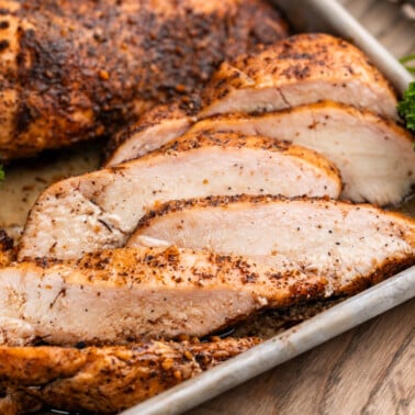 Close up view of smoked, sliced chicken breasts.
