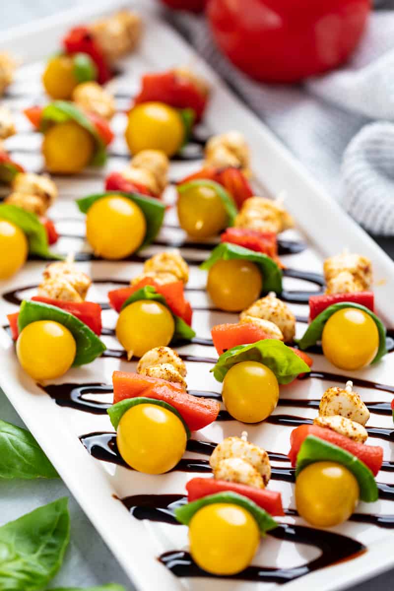 a tray of southwestern caprese bites drizzled with balsamic vinegar