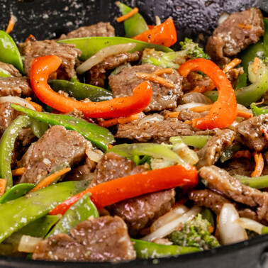 Close up view of takeout beef stir fry in a wok.
