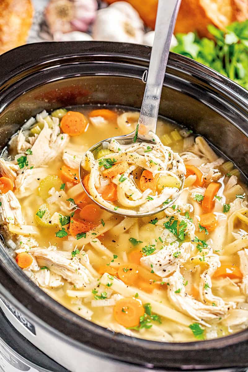 Chicken noodle soup in a slow cooker. 
